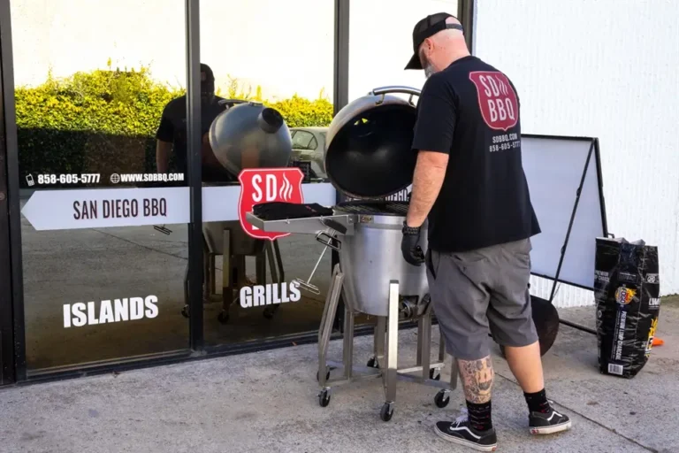 San Diego BBQ technician cleaning a BBQ grill outside the storefront in Carlsbad, California.