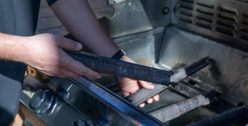 Close-up of grill cleaning, removing grease from grate