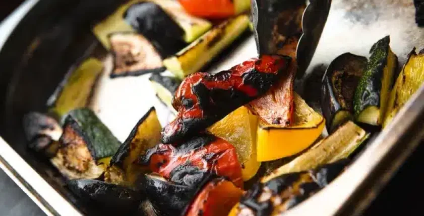 Baked mixed vegetables in a stainless steel tray